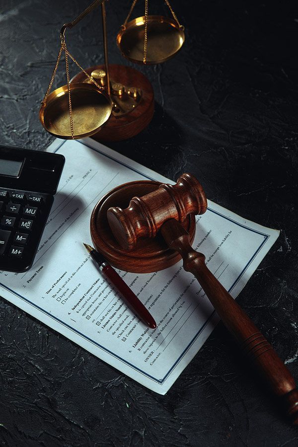 Gavel and brass scales on a signed legal document